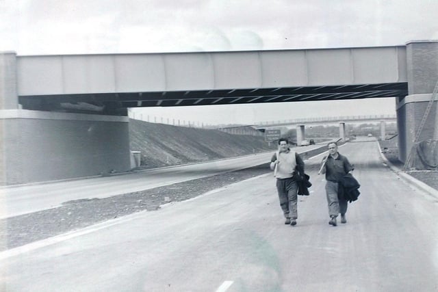 This image from a glass plate negative shows workmen, finished for the day, with the knowledge and satisfaction that they have contributed to the making of the new Lancaster Motorway (M6) which was due to be opened. The picture was taken just north of Carnforth.