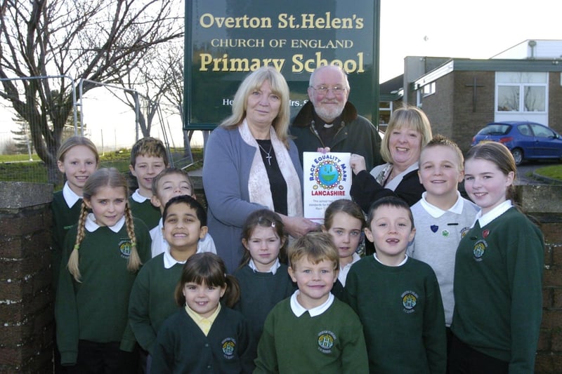 Headteacher at Overton St Helen's Sammy Clarke receives a Race Equality Mark in 2008 from teacher advisor Jane Richmond and Rev David Newton along with some pupils from the school.