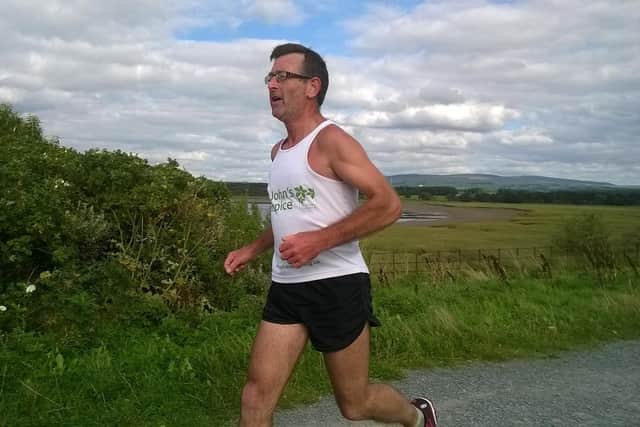 Mark Houghton sprinting for the finish after his 81 mile run from Walney Island to Glasson Dock in aid of St John's Hospice.