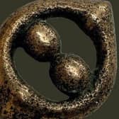 A copper alloy mount, circa 43-200 CE, discovered among a Third Century Roman hoard in Silverdale.