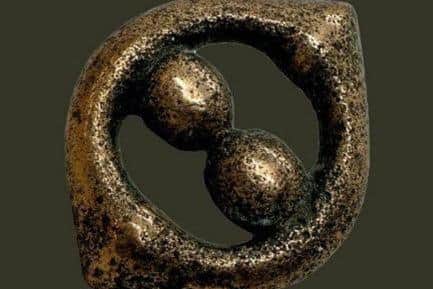 A copper alloy mount, circa 43-200 CE, discovered among a Third Century Roman hoard in Silverdale.