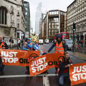 Just Stop Oil protesters block the road at the junction of Cannon Street and Queen Victoria Street in London on October 27 2022 in London, England. Photo by Jeff J Mitchell/Getty Images