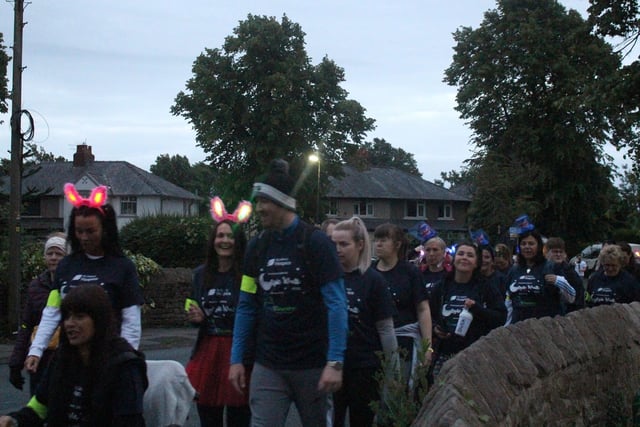 Some of the walkers light the way with bunny ears.