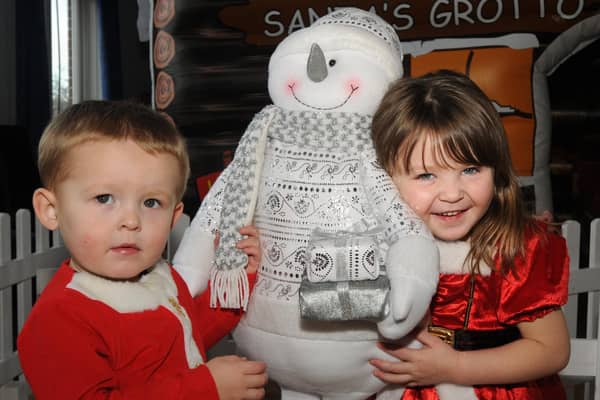Morecambe and Lancaster Home Start hold a family Christmas party at Trimpell Sports and Social Club. Brother and sister, two-year-old William and three-year-old Victoria Moorehouse from Morecambe, with some of the Christmas figures at the party,