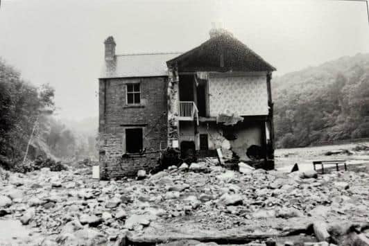Backsbottom Farm, the home of Bill and Alice Brown, was the first obstacle in the torrent's way as it flowed down the narrow valley towards Wray. Here, the farm is a ruin amid a wilderness of rocks, tree trunks, mud and water. Picture courtesy of David Kenyon.