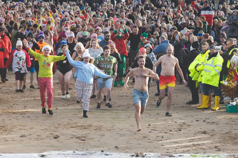 Hundreds braved the freezing water for the New Year's Day Dip in Morecambe Bay for the hospice.