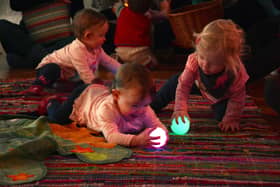 Three babies having fun with glow balls at a previous Magic Islands. Photo: Darren Andrews.