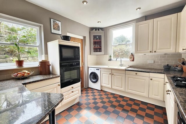 The kitchen enjoys a traditional feel with quarry tile flooring.