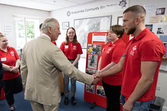 The Prince of Wales meets Tom during his visit to Morecambe Community Fire Station to view the work of The Princes’ Trust and the Lancashire Fire and Rescue Service.