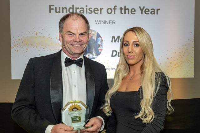 Fundraiser of the Year winner Mark Dugan receives his award from Ashleigh Flint, sales manager for the Morecambe Visitor.