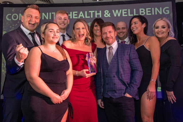 Community Health and Wellbeing Award winners 3-1-5 X-Force pick up their prize from Travis Perkins  Morecambe Branch Manager, Graham Kemp (front right). Runners-up were BayFit Performance PT and Re:Set Mind Body Soul.