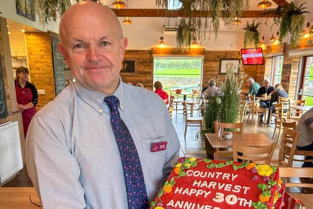 Managing Director Mike Clark with the special anniversary cake at Country Harvest in Ingleton.