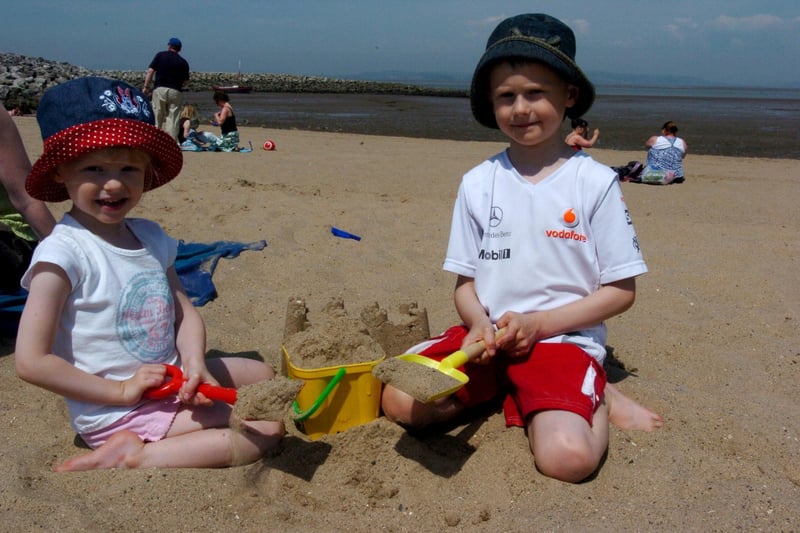 Sienna and Nathan Harrison from Morecambe making sandcastles on Morecambe beach.