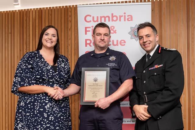 Karl Read is presented with his award by Kristine Ward, head of people and talent, and Rick Ogden, chief fire officer. Photo by Harry Atkinson