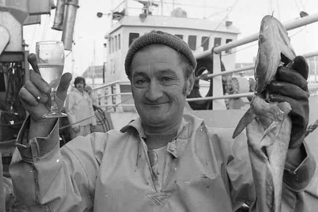 Cheer! Champagne and fish for port employee Arthur Bailey at Fleetwood, as the first Icelandic trawler to fish at Fleetwood arrived, under a new deal to safeguard local industry