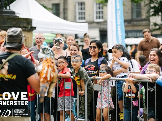Children eager to meet one of the mini dinosaurs at Dino Fest in Lancaster. Picture by Ginny Koppenhol.