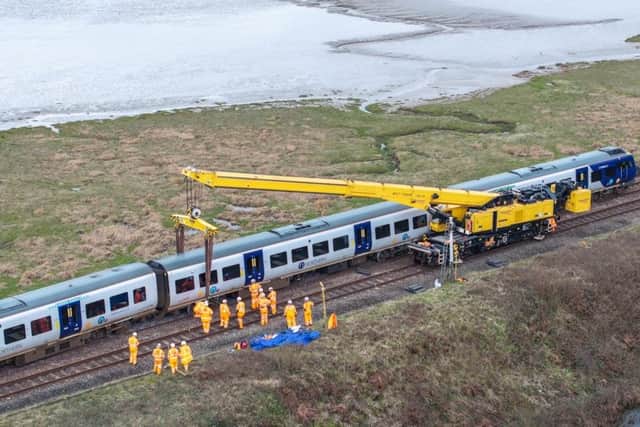 A specialist crane rerailing the train at Grange-over-Sands.