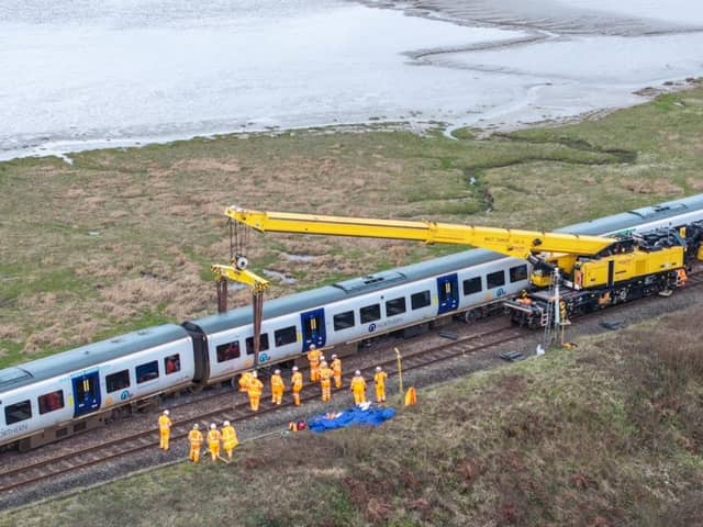 A specialist crane rerailing the train at Grange-over-Sands.