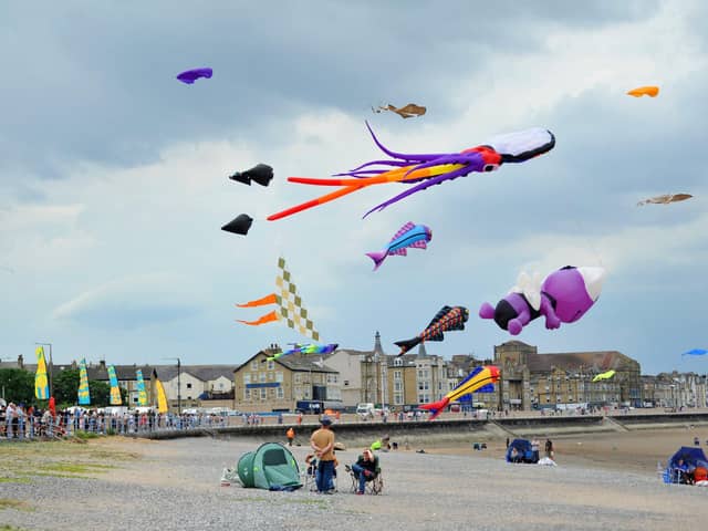 MORECAMBE - 25-06-23  Family fun at the Catch the Wind Kite Festival with street performers and entertainment along Morecambe Promenade.