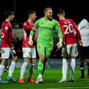 Morecambe goalkeeper Connor Ripley celebrates after saving a second penalty against Derby County