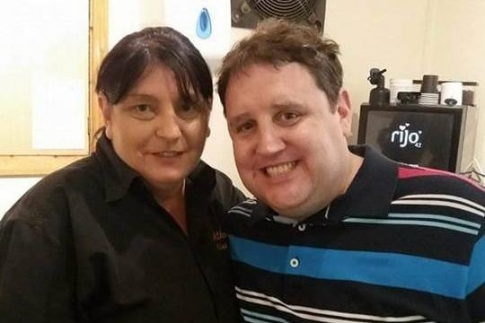 Comedian Peter Kay poses for a photo with Bernadette Harkin at Atkinson's chippy in Albert Road, Morecambe, in August 2017.