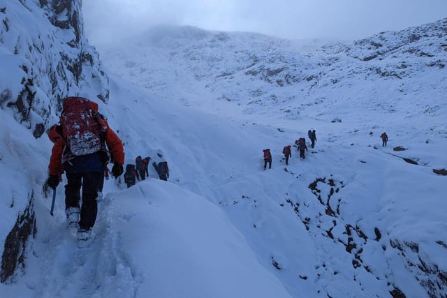 Rescue teams trudge in the snow to reach Ben Longton who was stranded.