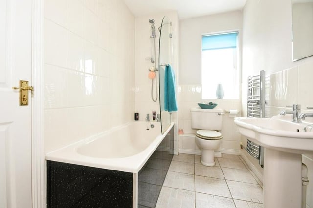 The family bathroom sits between bedrooms three and four at the back of the first floor. A white suite comprises bath, with shower over, low-flush WC, hand wash basin and heated towel-rail.