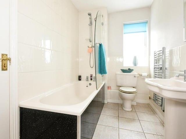 The family bathroom sits between bedrooms three and four at the back of the first floor. A white suite comprises bath, with shower over, low-flush WC, hand wash basin and heated towel-rail.