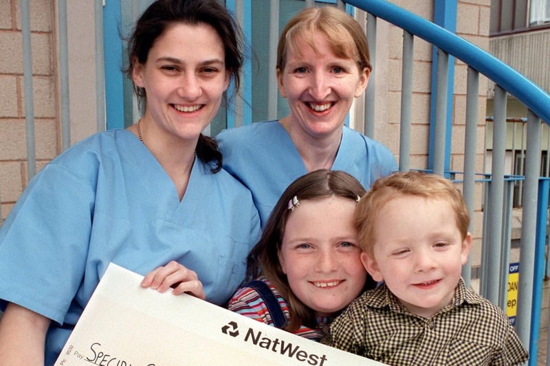 Kim Mason-Milward with brother Jamie presents Staff Nurse Liz Chamberlain and Sister Lynn Watson from Lancaster's Royal Lancaster Infirmary Neonatal Unit with a cheque for £100.