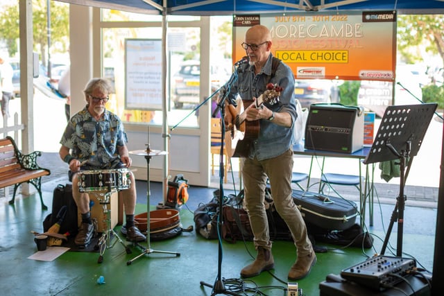 Morecambe Music Festival Acts perform at various venues on the promenade and around the town centre. Pictured - Playing at the Festival Market: Singer David Woods and Ian Hunter (Drums) 10.07.2022. Picture by Anthony Farran.