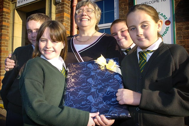 Teaching assistant Jean Hackney retired from Shakespeare School in Fleetwood after 18 years. The pupils who Jean had looked after the longest say farewell with a gift (pictured from left to right) Robbie Greenhalgh, Rebecca Cowell, Peter Bidle, and Caroline Porter