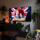 A woman watches an episode of the newly released Netflix docuseries "Harry and Meghan" about Britain's Prince Harry, Duke of Sussex, and Britain's Meghan, Duchess of Sussex, in London. Picture: Daniel Leal/AFP via Getty Images