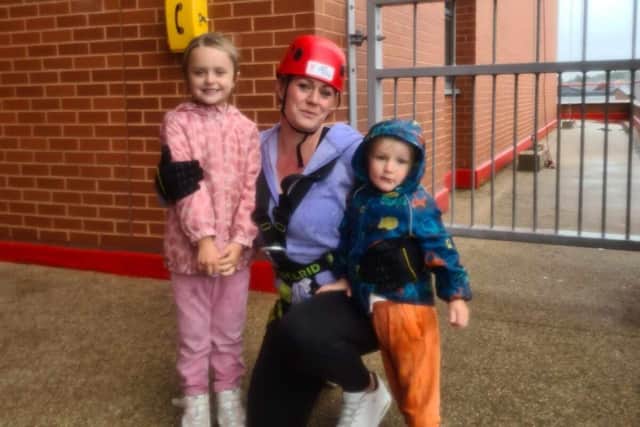 Clare Lyden with her children, Lucy and Toby, after her successful abseil.