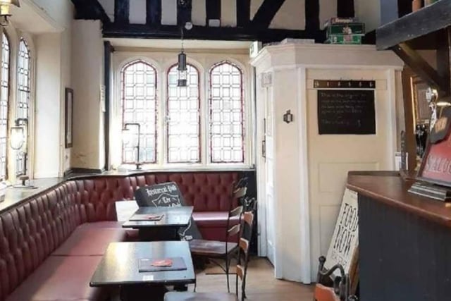 Stained glass windows and timbered walls in the smaller bar area.