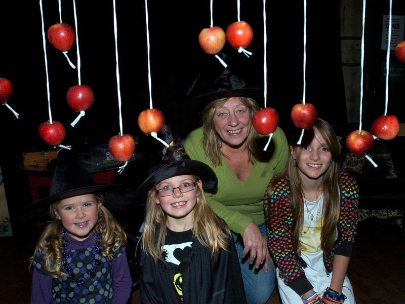 Holly Watkins-New, Isobel Pye, Lilly Blach-Davies and Katherine Bevington on the apple bobbing stall at a Halloween party at The Gregson.
