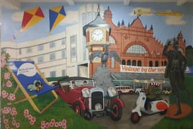 Street artist Bob Pickersgill has painted a mural at a Morecambe caravan park which brings the resort to life.
