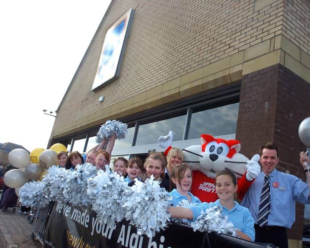 Heysham High School's cheerleaders and Morecambe FC mascot Christie The Cat were on hand at the reopening of Morecambe's extended ALDI store, where they are pictured with store manager Tim Robinson and assistant manager Amy Stevens.