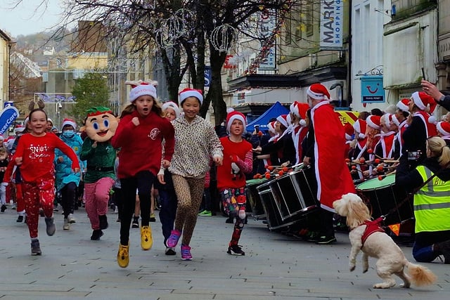 A friendly dog supports some of the youngsters taking part in the Santa Dash.