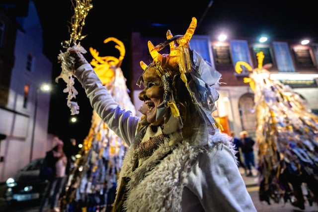 A woman in costume with a head dress takes part in the lantern festival parade in Morecambe. Picture by Robin Zahler courtesy of More Music in Morecambe.
