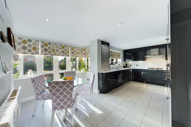 The open-plan kitchen/diner has base and wall units, quartz worktops and integrated appliances.