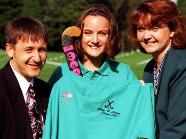 Communications officers Kevin Demain and Jackie Rowley seen presenting a new strip on behalf of Heysham Power Stations to captain Sarah Campbell for the Ripley St Thomas CE School hockey squad.