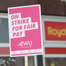 A sign held by a postal worker from the Communication Workers Union (CWU) on the picket line at a Royal Mail Delivery Office.Picture by James Manning/PA Wire