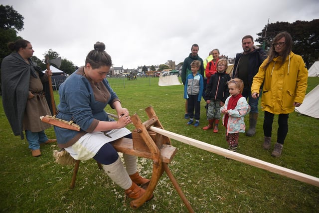 People look on at one of the viking's doing woodwork. Picture by Daniel Martino.