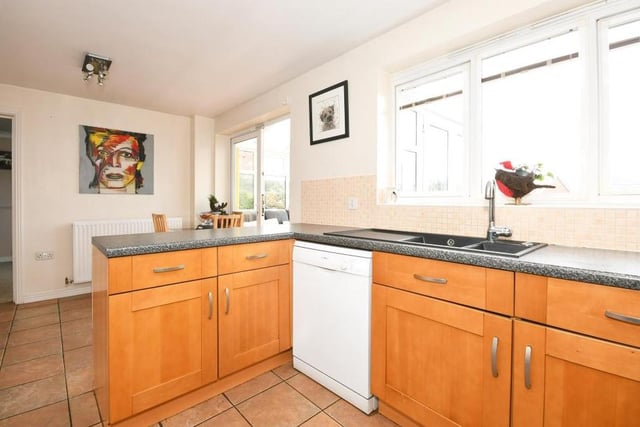 A third photo of the kitchen/diner, with its window overlooking the back garden. The room has access to the property's conservatory and also a handy, separate utility room.