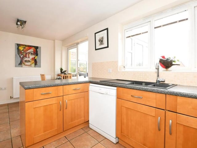 A third photo of the kitchen/diner, with its window overlooking the back garden. The room has access to the property's conservatory and also a handy, separate utility room.
