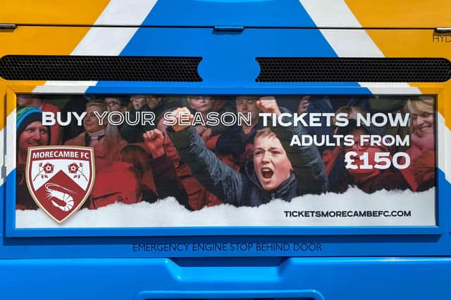 Advertising Morecambe FC season tickets on a bus.