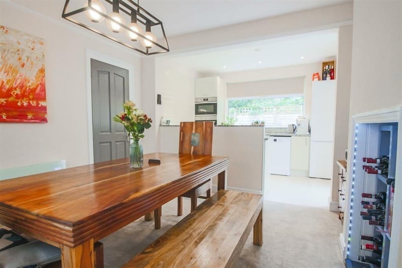 The open plan kitchen dining room with a bay window to the front elevation and an alcove into the chimney breast – currently used for a wine rack.