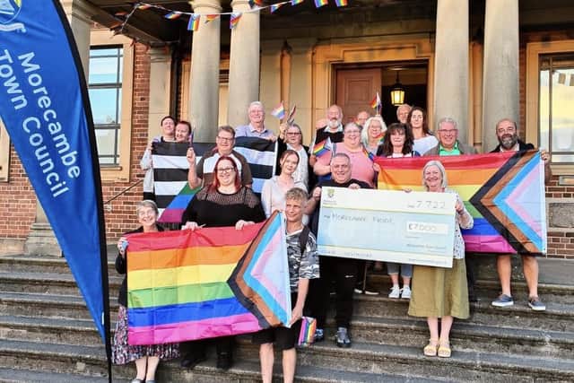 Councillors and representatives from Morecambe Pride celebrating funding being awarded to the festival after the town council did a u-turn.