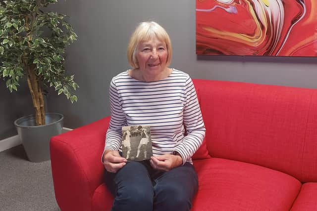 Elizabeth Altham (now Finley) with one of the photos that appeared in the Lancaster Guardian and Visitor.