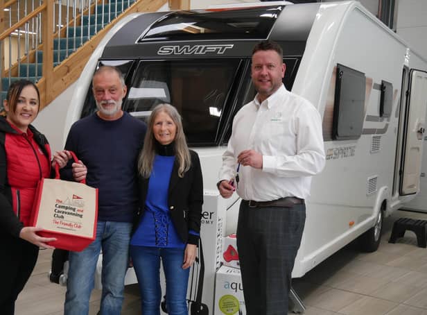 Michelle Jewell from The Camping and Caravanning Club and Matt Holmes from Swift Group present the prize to winners Cheryl and David Goss.